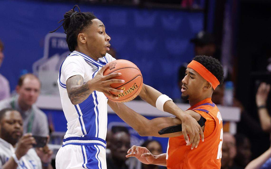 Clemson's Ace Buckner (21) fouls Duke’s Isaiah Evans (3) during the first half of Duke’s game against Clemson in the semifinals of the 2026 ACC Men’s Basketball Tournament at the Spectrum Center in Charlotte, N.C., Friday, March 13, 2026.