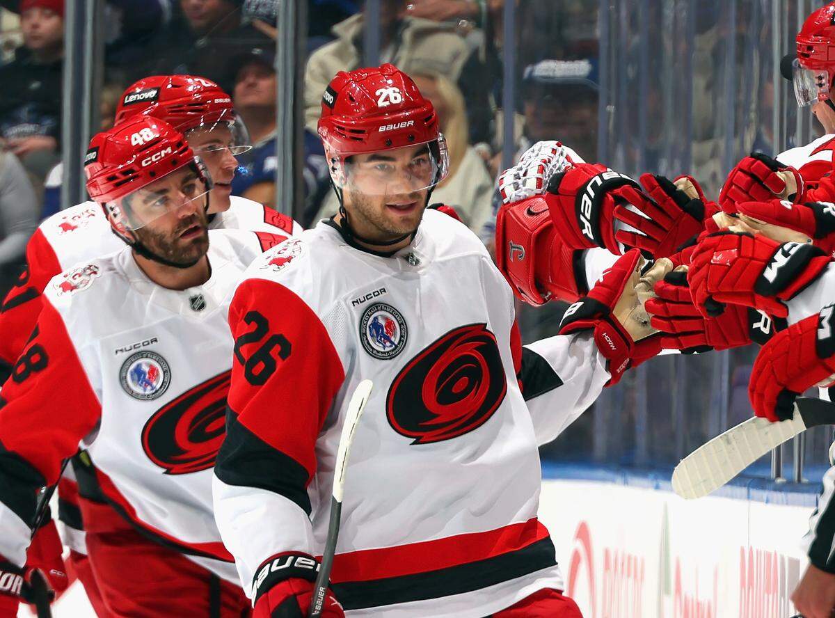 Sean Walker (26) of the Carolina Hurricanes celebrates his second-period goal against the Toronto Maple Leafs at Scotiabank Arena on Nov. 9, 2025 in Toronto, Ontario, Canada.