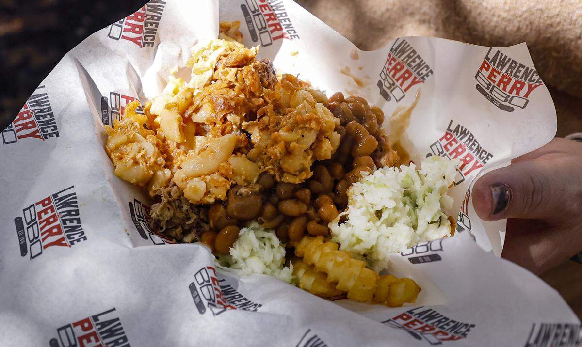 Attendees enjoyed a mini Slop Bucket from Lawrence & Perry BBQ during the Foodie's Tour of the State Fair at the N.C. State Fair in Raleigh, N.C., Friday, October 17, 2025.