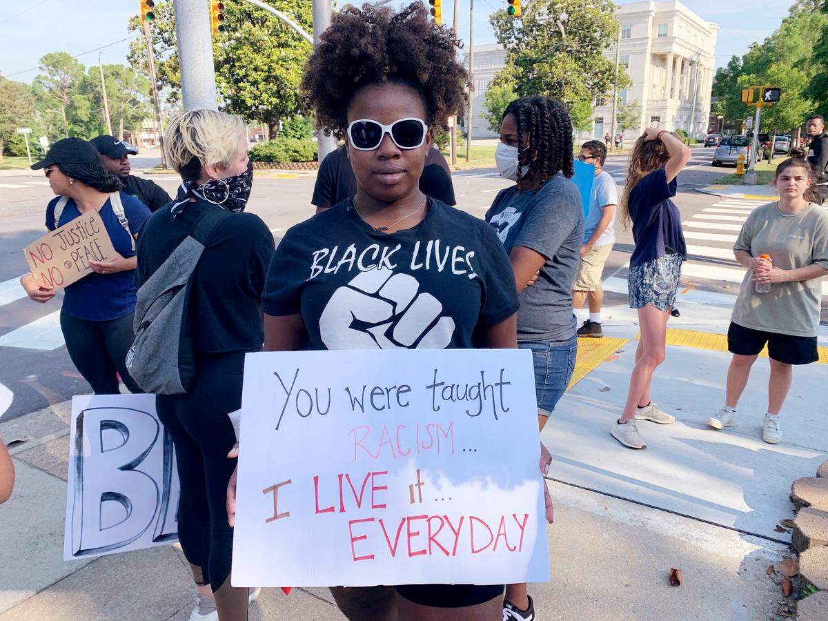 Kayla Beasley, a 20-year-old N.C. State student, came out to protest for the first time on Thursday, June 4, 2020, in downtown Raleigh. ÒHistory keeps repeating itself and itÕs time for change,Ó Beasley says.
