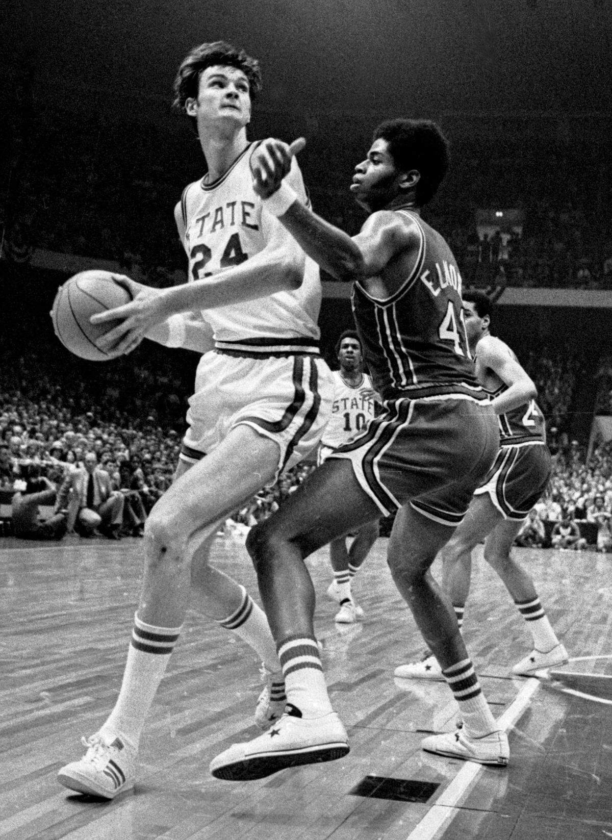 N.C. State center Tommy Burleson drives against Maryland center Len Elmore in the 1974 ACC Tournament championship game. The Wolfpack won that game on the way to the national championship.