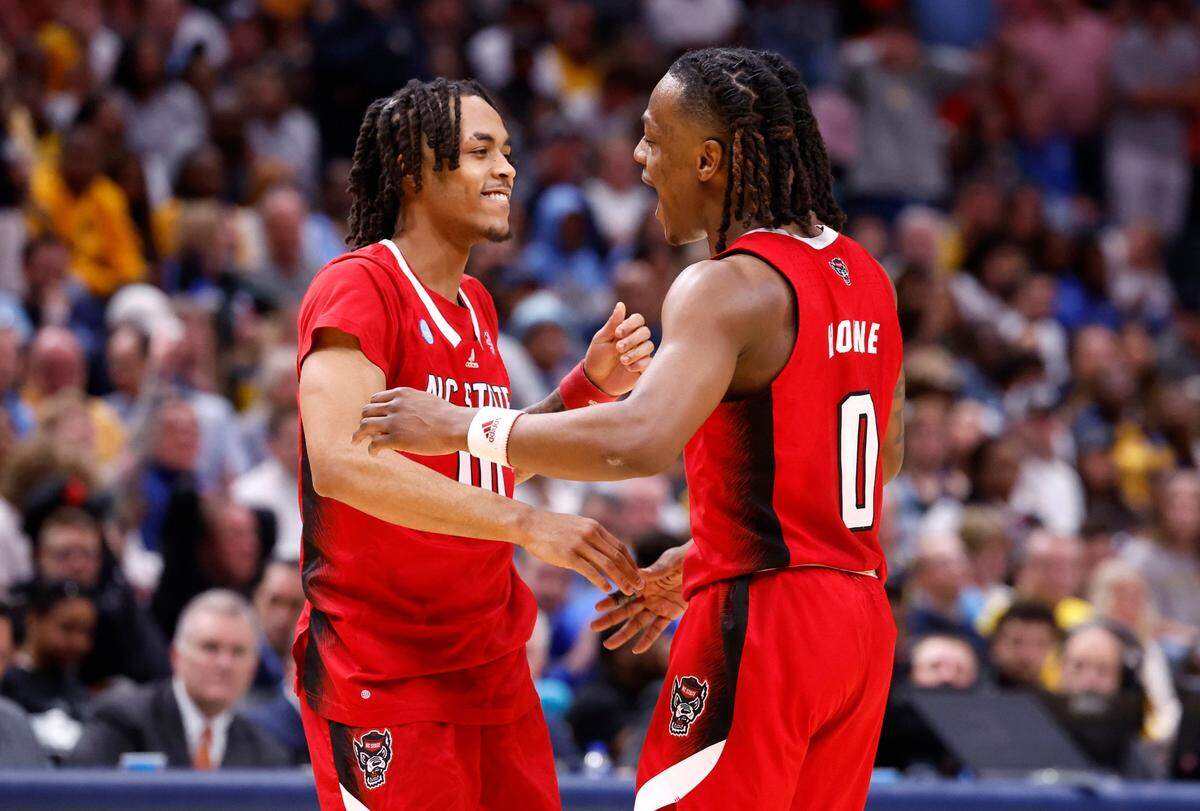 N.C. State’s DJ Horne (0) celebrates with Breon Pass (10) as he comes out of the game late in the second half of N.C. State’s 67-58 victory over Marquette in their NCAA Tournament Sweet 16 game at the American Airlines Center in Dallas, Texas, Friday, March 29, 2024.