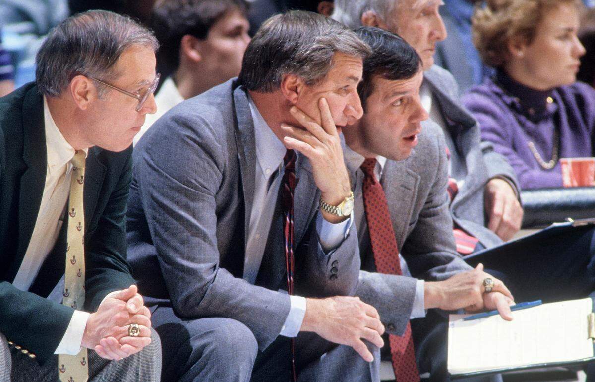North Carolina assistant basketball coach Roy Williams, right, confers with head coach Dean Smith, center, as assistant coach Bill Guthridge looks on during a game in the 1980s. All three ended up serving as head coach.