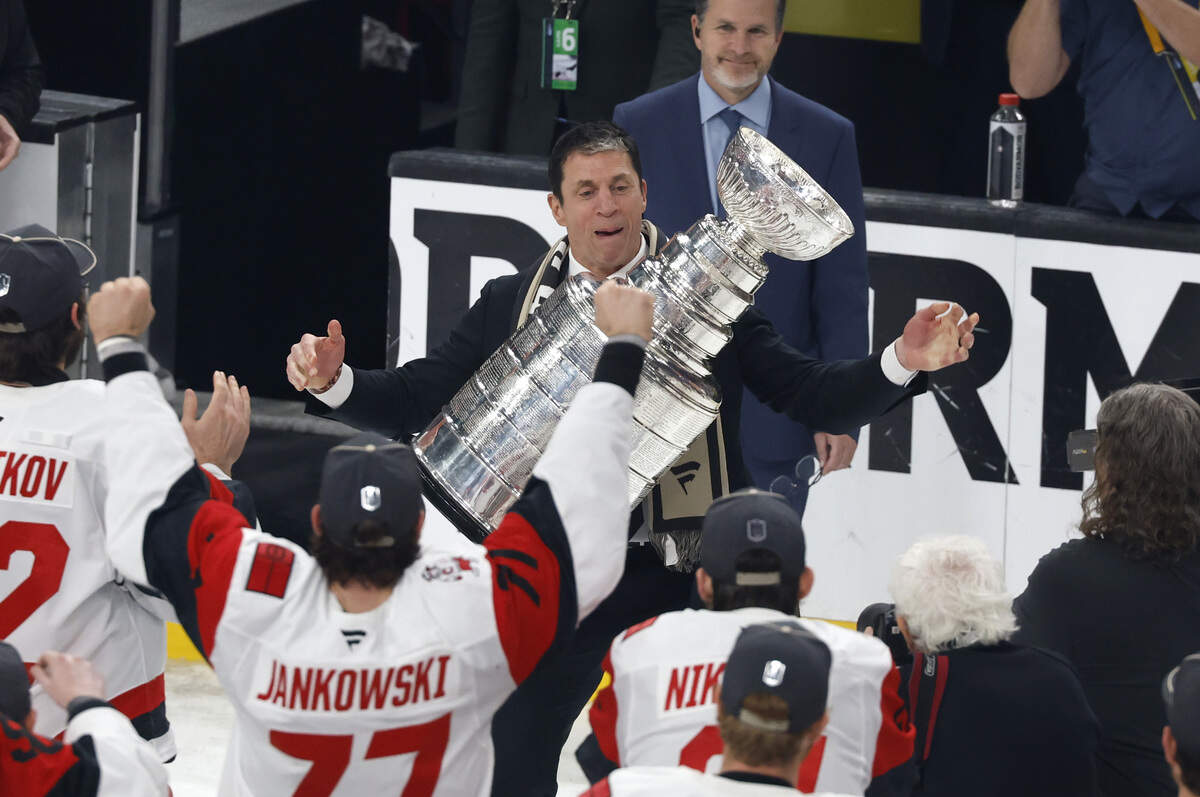 Canes coach Rod Brind'Amour adjusts the Cup before raising it after the Hurricanes’ 3-0 victory over the Vegas Golden Knights to win the Stanley Cup at T-Mobile Arena in Las Vegas, Nev., Sunday, June 14, 2026.