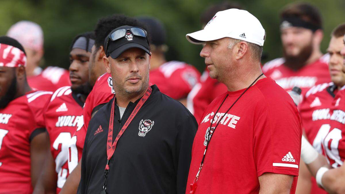 N.C. State quarterbacks coach Kurt Roper, left, talks with head coach Dave Doeren during the Wolfpack’s practice in Raleigh, N.C. Tuesday, August 6, 2019.