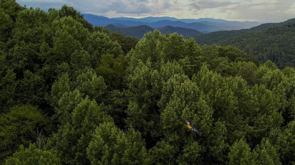 Zipline canopy tour guide Ben DeBarros rides the “Squealing Mare” a 1550 foot-long and 250 foot-high zipline at Highlands Aerial Park in Scaly Mountain.