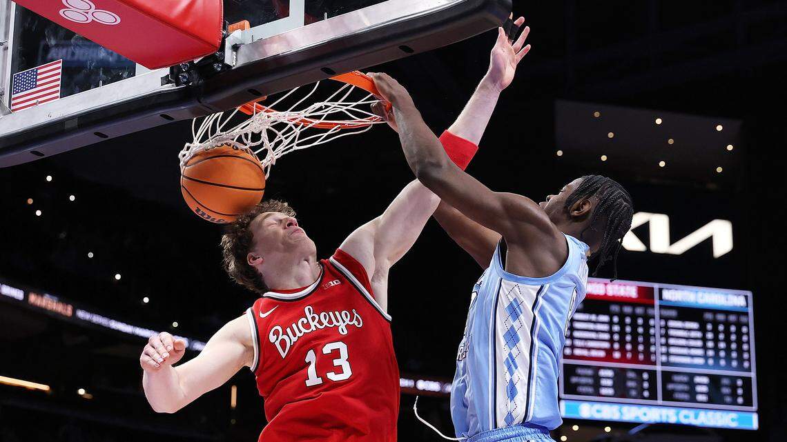 Caleb Wilson (8) of the North Carolina Tar Heels dunks against Christoph Tilly (13) of the Ohio State Buckeyes during the second half.