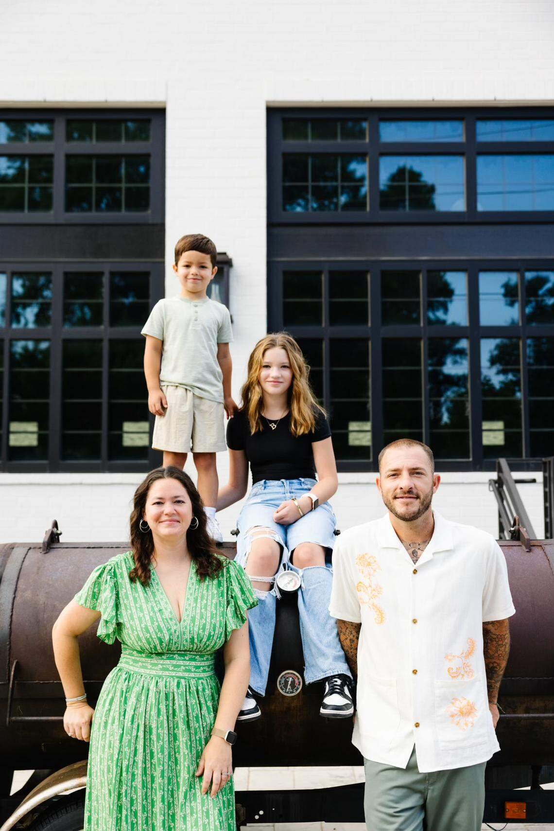 Jake Wood is relocating his Lawrence Barbecue operation to downtown Cary next summer. Wood is shown with his wife Brandi and children Breanna and Lawrence outside the new location at 150 E. Cedar St. in Cary.