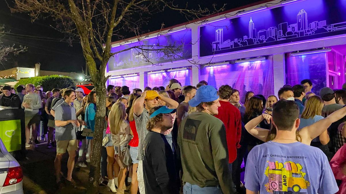 Crowds pack Glenwood Avenue on Friday, March 26, 2021, in the area known as Glenwood South as Gov. Roy Cooper relaxed COVID-19 restrictions on bars and restaurants. Masks and social distancing are still required.
