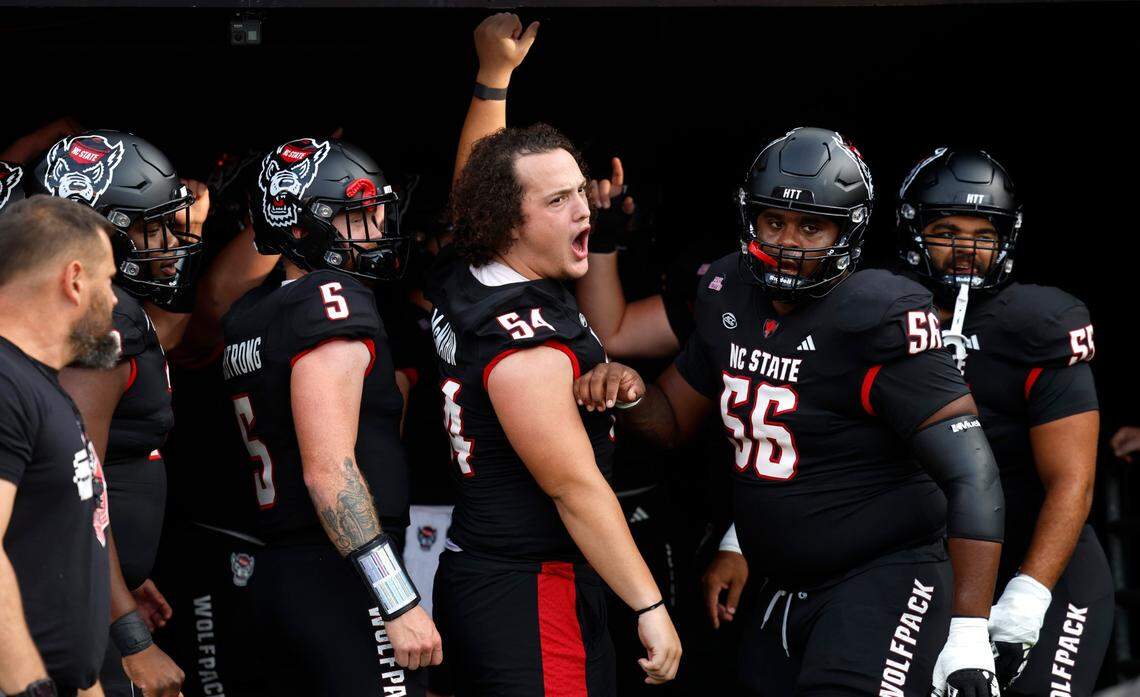 N.C. State offensive lineman Dylan McMahon (54) leads the centers and quarterbacks onto the field to warmup before N.C. State’s game against Louisville at Carter-Finley Stadium in Raleigh, N.C., Friday, Sept. 29, 2023.
