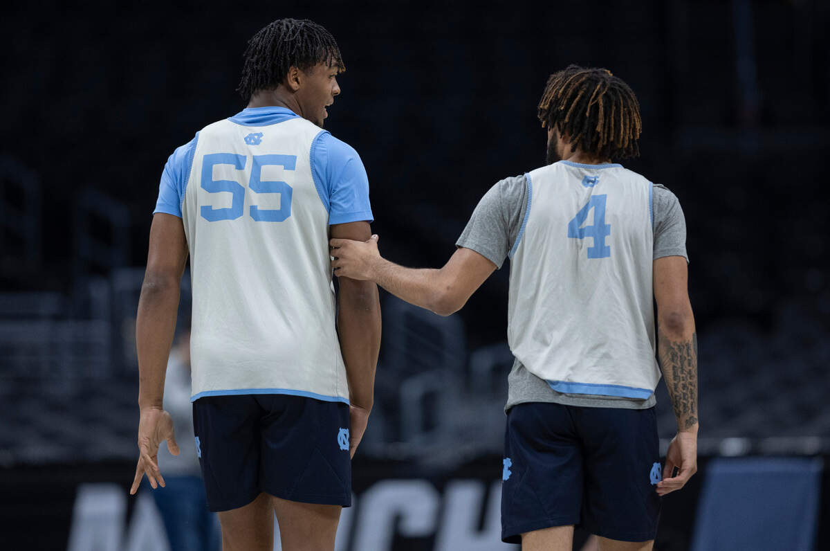 North Carolina’s R.J. Davis (4) holds teammate Harrison Ingram’s arm as they talk during the Tar Heels’ open practice on Wednesday, March 27, 2024 at Crypto.com Arena in Los Angeles, CA.