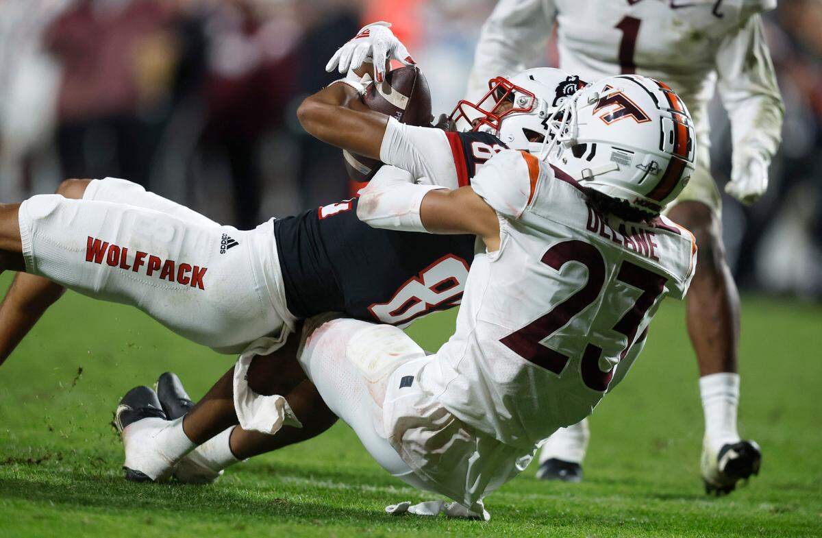N.C. State wide receiver Terrell Timmons Jr. (82) pulls in a long reception as Virginia Tech defensive back Mansoor Delane (23) defends during the second half of N.C. State’s 22-21 victory over Virginia Tech at Carter-Finley Stadium in Raleigh, N.C., Thursday, Oct. 27, 2022.