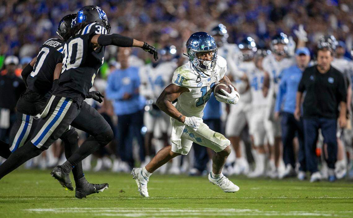 North Carolina’s Josh Downs (11) looks for running room after an 11-yard pass reception from quarterback Drake Maye to set up the Tar Heels’ game winning touchdown in the final minute of play on Saturday, October 15, 2022 at Wallace-Wade Stadium in Durham, N.C.