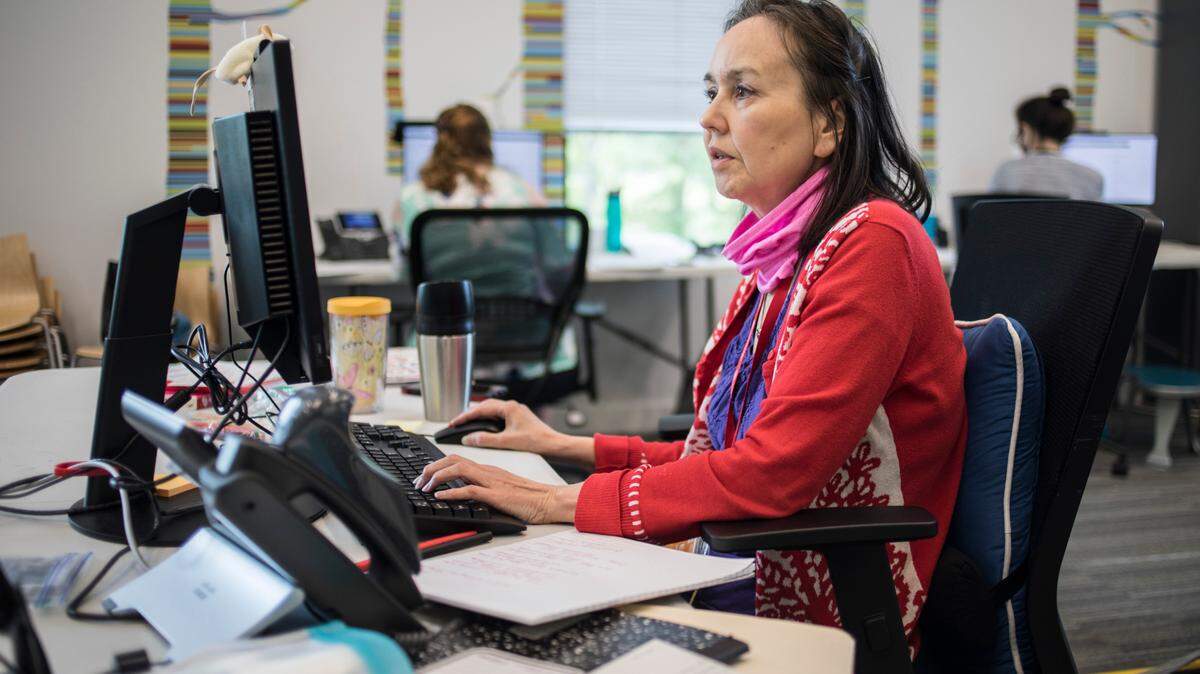 Librarian Linda Winkler works at her computer as a contact tracer for the Wake County Health Department at Cary Regional Library on Thursday, June 18, 2020.