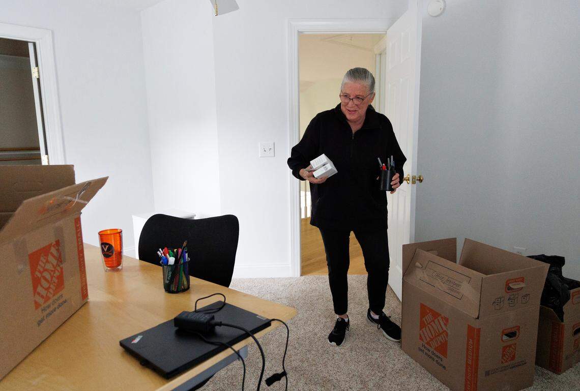 Annabella Vagonis unboxes belongings in the office of her new home in Chapel Hill, N.C. The Vagonises are among the baby boomers buying new homes and squeezing the market.
