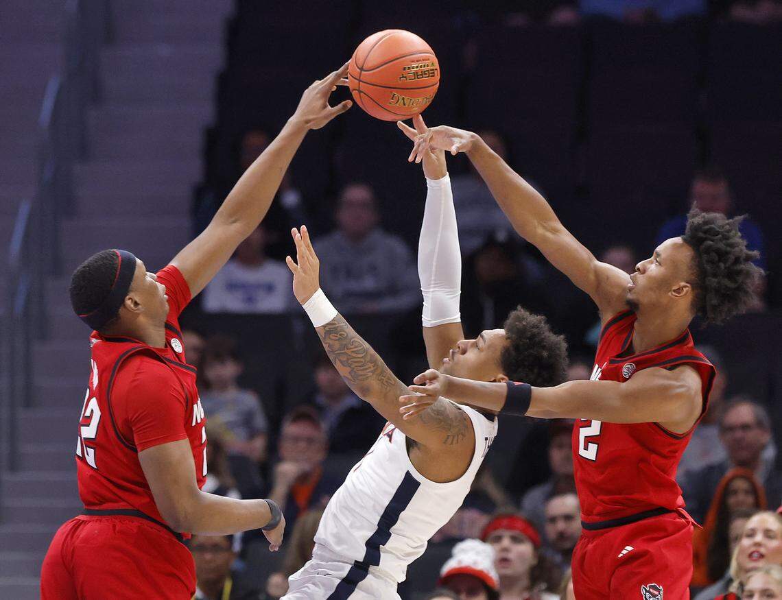 N.C. State's Ven-Allen Lubin and Paul McNeil Jr. pressure Virginia's Malik Thomas during the first half of the Wolfpack’s ACC Tournament quarterfinal game onThursday, March 12, 2026, at the Spectrum Center in Charlotte, N.C. 