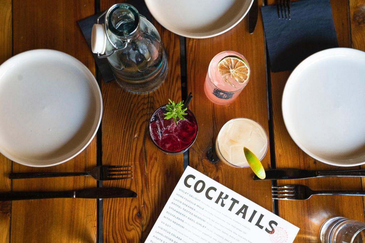 Young Hearts Distilling in downtown Raleigh, N.C. is a balcony bar that offers a wide variety of eccentric cocktails, including these, the Galaxy Paloma, Honeysuckle Mule with the house brand of vodka, and a blueberry lemonade.