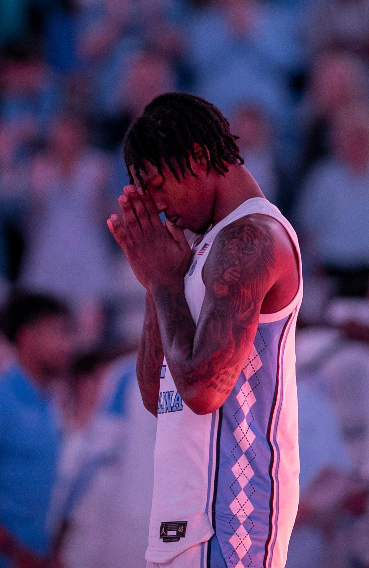 North Carolina’s Caleb Love (2) says a prayers prior to the tip off against College of Charleston on Friday, November 11, 2022 at the Smith Center in Chapel Hill, N.C.
