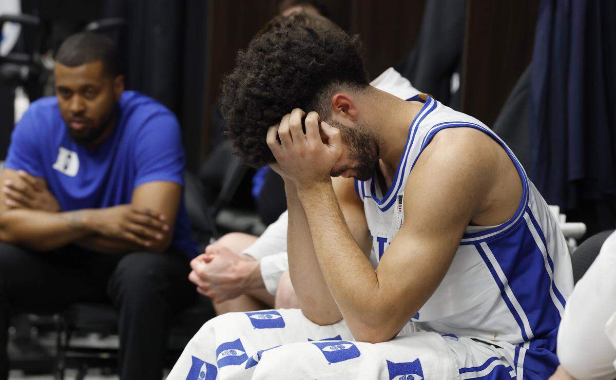 Duke’s Cayden Boozer sits in the locker room after UConn’s 73-72 victory over Duke in the NCAA Men’s Tournament East Regional Final at Capital One Arena in Washington, D.C., Sunday, March 29, 2026.
