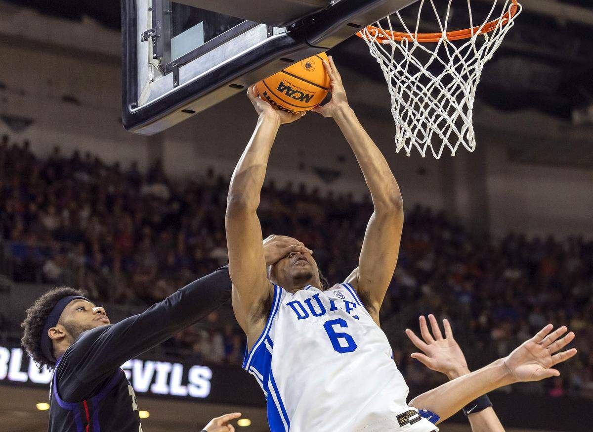 Duke forward Maliq Brown (6) gets a hand in his face from TCU forward David Punch (15) in the first half on Saturday, March 21, 2026, during the second round of the NCAA Tournament at Bon Secours Arena in Greenville, S.C.