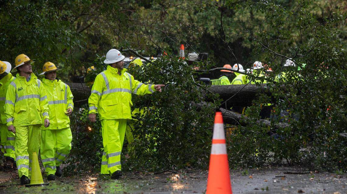 Crews work to clear a downed tree near the intersection of Gresham and Shenandoah Avenues as the Triangle feels the effects of Hurricane Ian on Friday, Sept. 30, 2022, in Durham, N.C.