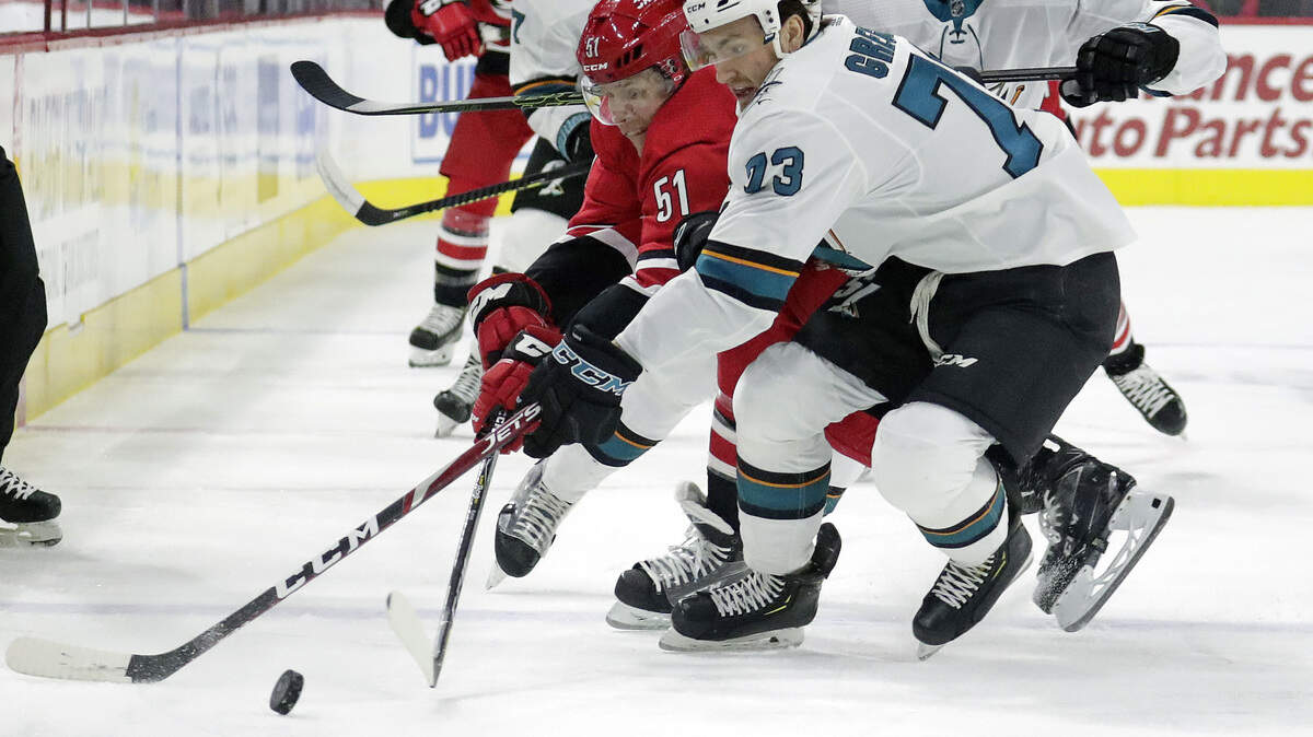 Carolina Hurricanes defenseman Jake Gardiner (51) battles for the puck with the San Jose Sharks’ Noah Gregor (73) on Thursday. Gardiner scored his second goal of the season.