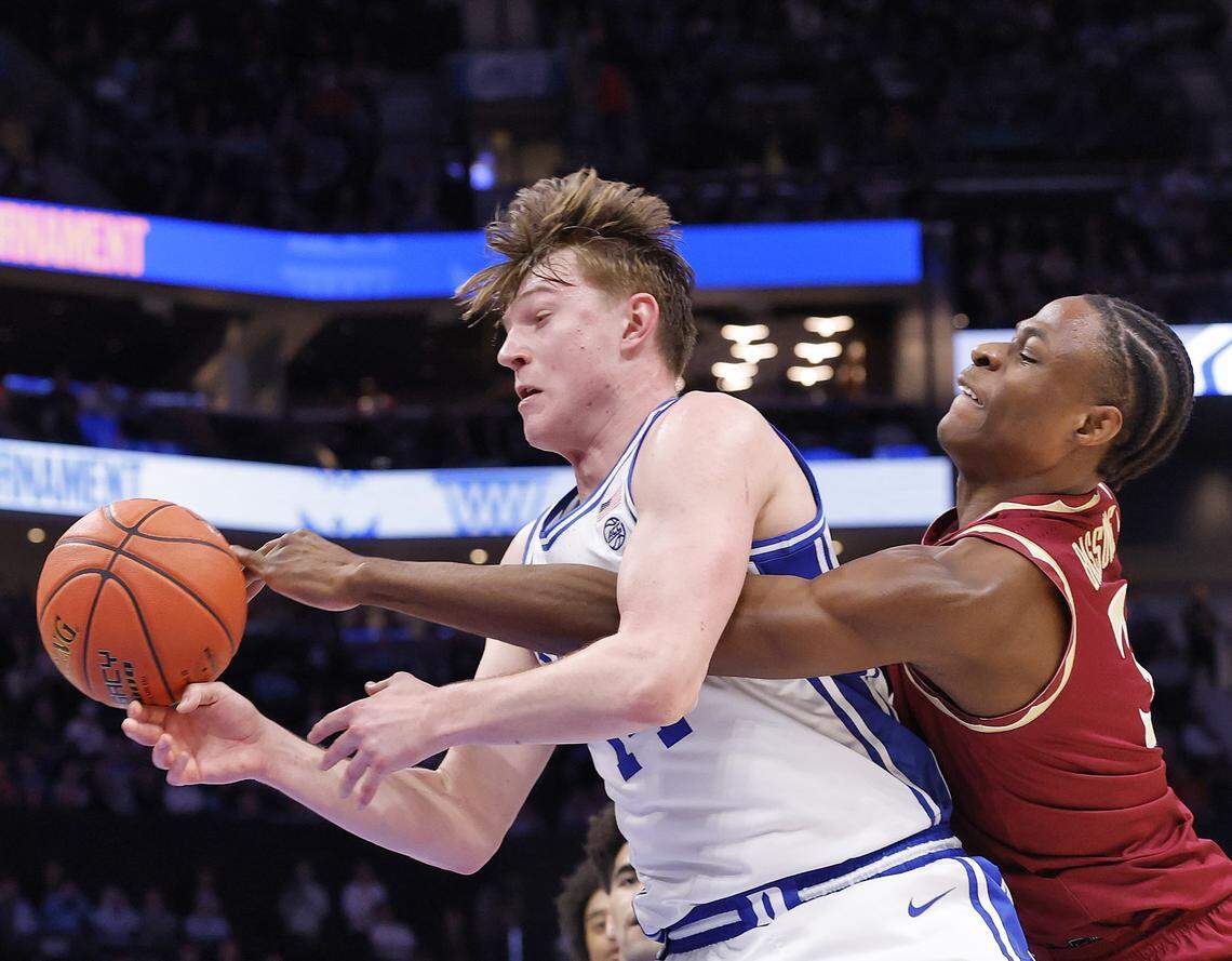 Duke’s Nikolas Khamenia and Florida State's Thomas Bassong battle for a loose ball during the second half of the Blue Devils’ 80-79 win in the ACC Tournament quarterfinals on Thursday, March 12, 2026, at the Spectrum Center in Charlotte, N.C. 