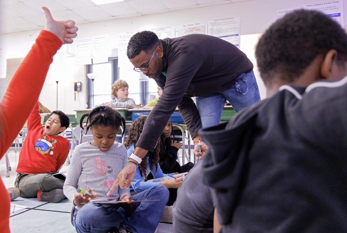 Pittsboro Elementary School teacher Shane Henderson and fourth-grader Nailah McMillan during class. 