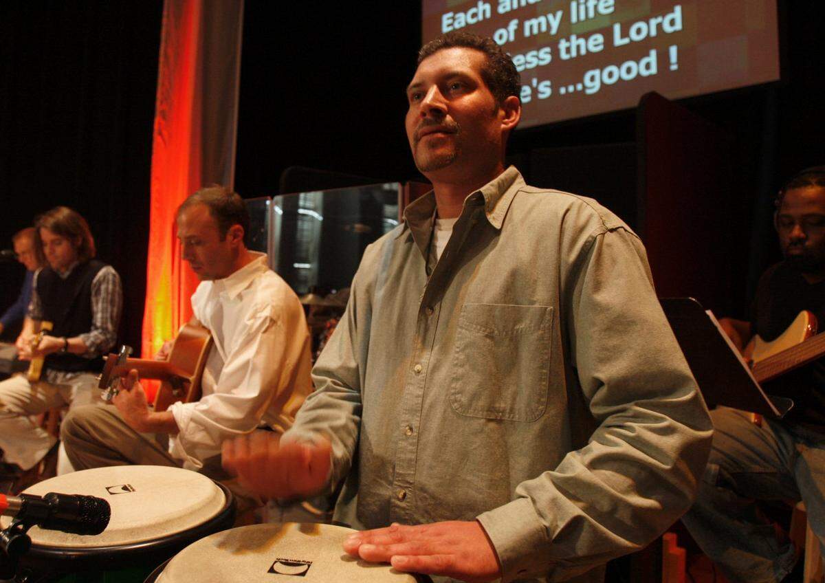 Rob Frohlking plays the conga drum in the band at “The Gathering” in 2010.