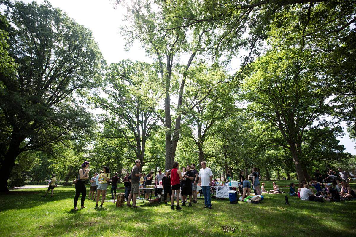 Anti-racist protesters hold a potluck on McCorkle Place, where the Confederate monument known as Silent Sam once stood, on Saturday, May 4, 2019. Pro-Confederate protesters held a rally across the street in Peace and Justice Plaza.