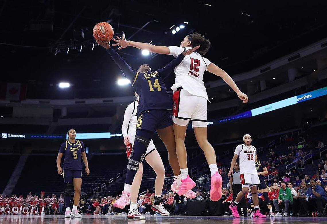 DULUTH, GEORGIA - MARCH 06: Kk Bransford #14 of the Notre Dame Fighting Irish attacks the basket against Khamil Pierre #12 of the NC State Wolfpack during the fourth quarter of the quarterfinals of the Women's ACC Tournament between the NC State Wolfpack and Notre Dame Fighting Irish at Gas South Arena on March 06, 2026 in Duluth, Georgia. (Photo by Kevin C. Cox/Getty Images)