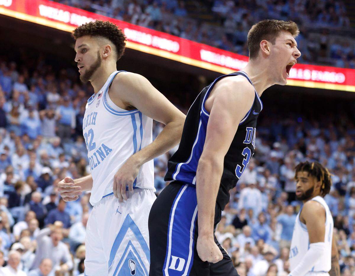 Duke’s Kyle Filipowski (30) celebrates making the dunk as he passes North Carolina’s Pete Nance (32) during the second half of Duke’s 62-57 victory over UNC at the Smith Center in Chapel Hill, N.C., Saturday, March 4, 2023.