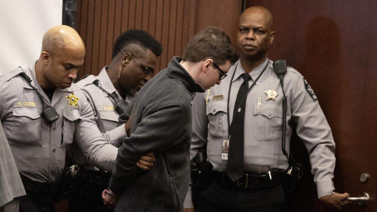 Deputies lead a handcuffed Austin Thompson from the courtroom after the teenager who confessed to killing five people in the east Raleigh neighborhood of Hedingham in 2022 was sentenced to five life sentences without the possibility of parole on Friday in Wake County.