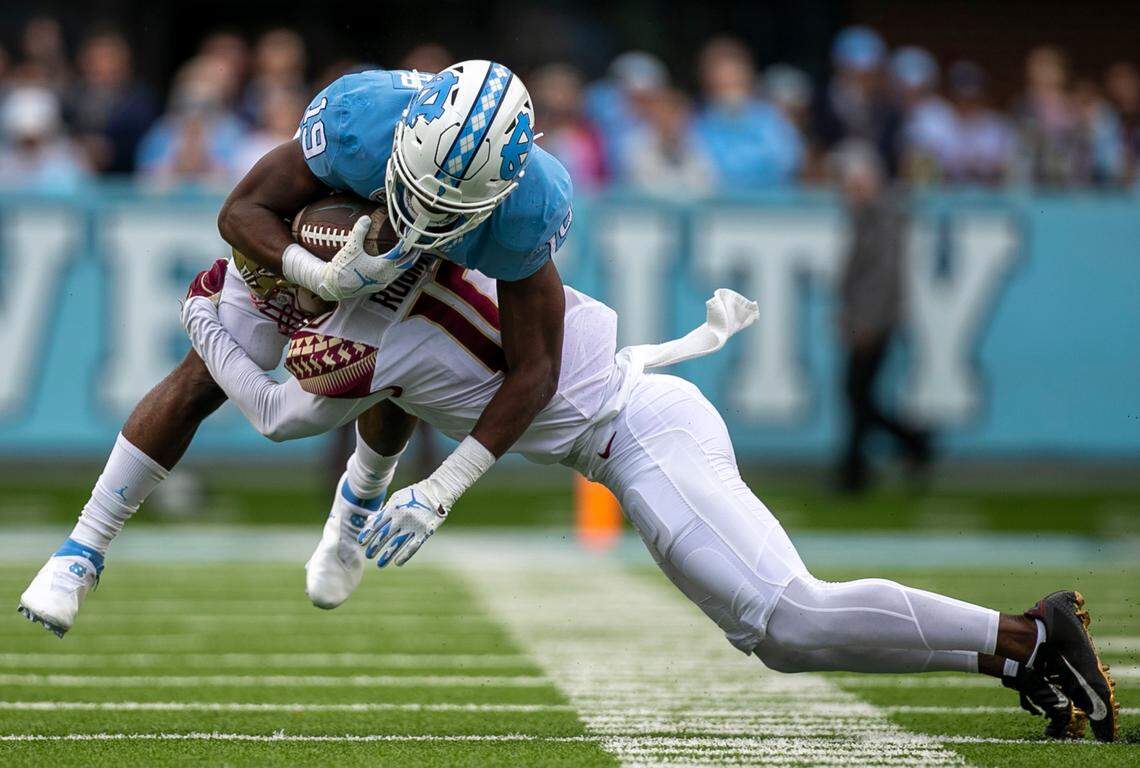 North Carolina running back Ty Chandler (19) is stopped by Jammie Robinson (10) after a six-yard gain in the first quarter on Saturday, October 9, 2021at Kenan Stadium in Chapel Hill, N.C.