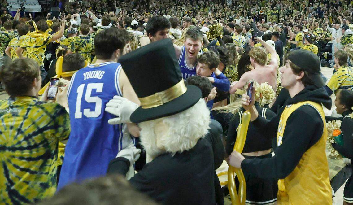 Duke’s Kyle Filipowski (30) is helped off the court after the Wake Forest fans rushed the court after Wake Forest’s 83-79 victory over Duke at Lawrence Joel Veterans Memorial Coliseum in Winston-Salem, N.C., Saturday, Feb. 24, 2024.