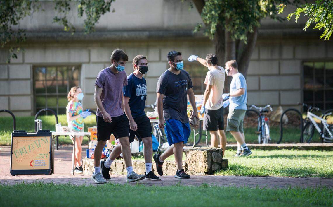 UNC-Chapel Hill students walk through Polk Place on the morning of the first day of class, Monday, Aug. 10, 2020.