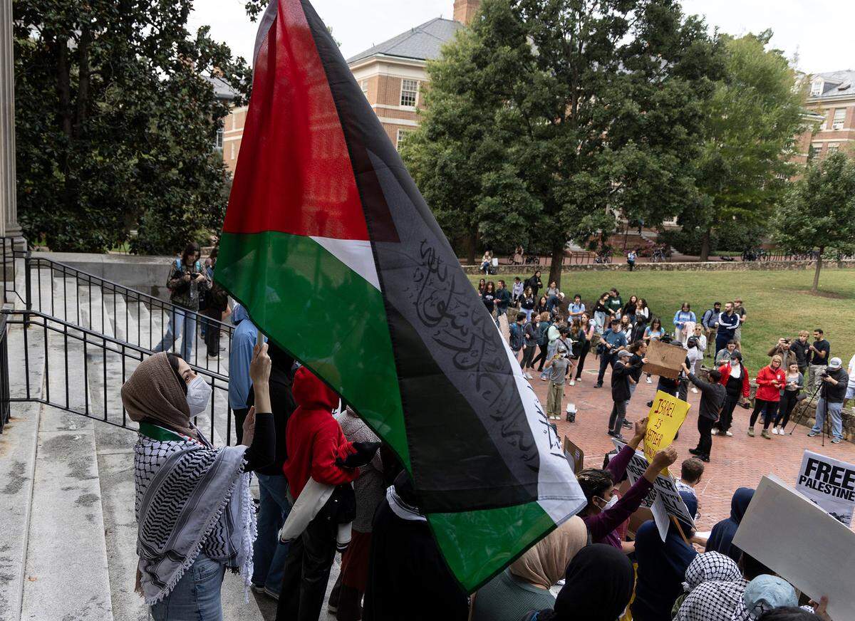 A person holds a Palestinian flag during a rally in support of Palestinians at UNC-Chapel Hill on Thursday, Oct. 12, 2023. The rally was organized by the UNC chapter of Students for Justice in Palestine.