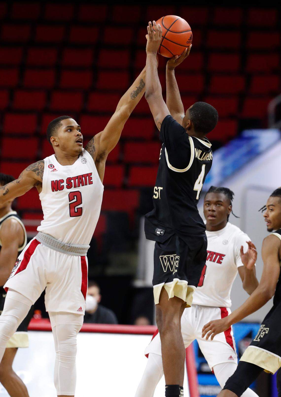 N.C. State’s Shakeel Moore (2) blocks the shot by Wake Forest’s Daivien Williamson (4) during the second half of N.C. State’s 72-67 victory over Wake Forest at PNC Arena in Raleigh, N.C., Wednesday, January 27, 2021.