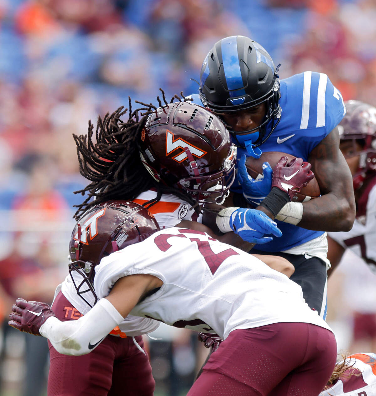 Duke Blue Devils running back Jordan Waters carries the ball past Virginia Tech Hokies defensive back Mansoor Delane and defensive back Nasir Peoples during the second half of a football game at Wallace Wade Stadium on Saturday, Nov. 12, 2022, in Durham, N.C.