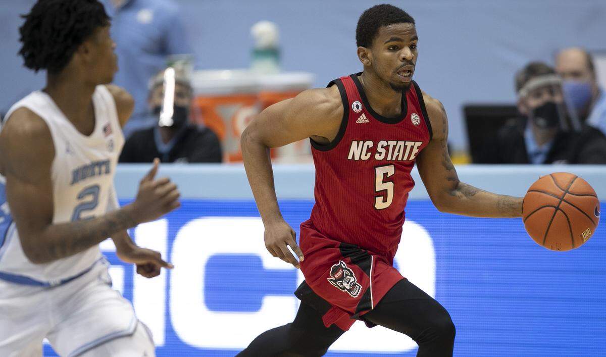 N.C. State’s Thomas Allen (5) runs a fast break ahead of North Carolina’s Caleb Love (2) in the second half on Saturday, January 23, 2021 at the Smith Center in Chapel Hill, NC.