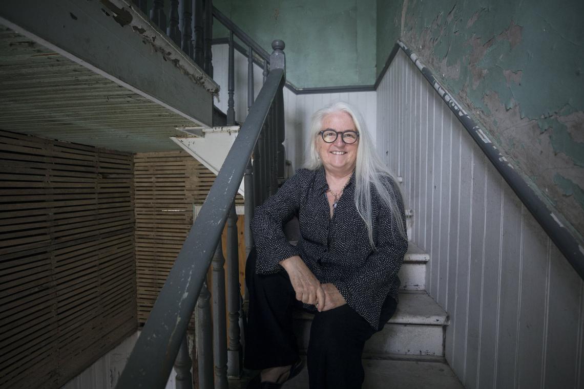 Executive Director of the Pauli Murray Center for History and Social Justice, Barbara Lau, poses for a portrait on the stairs inside Pauli Murray’s childhood home in Durham, N.C., on Tuesday, Sept. 21, 2021.