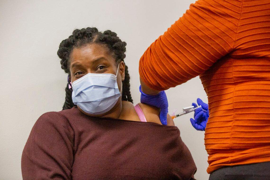 Rene Johnson, an advanced medical support assistant, receives a dose of the Pfizer COVID-19 vaccine from a fellow staff member at the Durham VA Medical Center, on Friday, Jan. 8, 2021, in Durham, N.C.