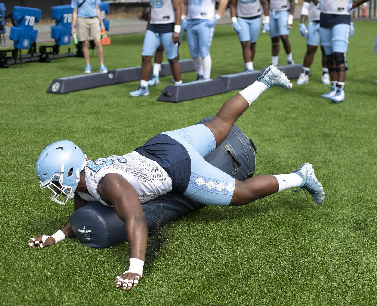 North Carolina defensive lineman Jason Strowbridge (55) takes out a blocking dummy during a drill at the Tar Heels’ first practice of the season on Friday, August 2, 2019 at the Football Practice Complex in Chapel Hill, N.C.