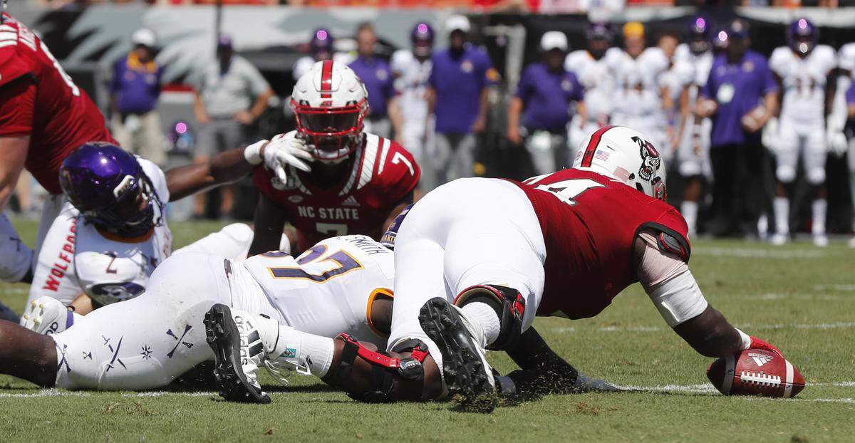 N.C. State offensive tackle Emanuel McGirt Jr. (74) dives on the loose ball during the first half of N.C. State’s game against East Carolina University at Carter-Finley Stadium in Raleigh, N.C., Saturday, August 31, 2019.