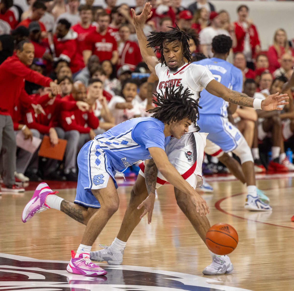 N.C. State’s Jayden Taylor (1) blocks North Carolina’s Elliot Cadeau (2) in the first half against North Carolina on Wednesday, January 10, 2024 at PNC Arena in Raleigh, N.C.