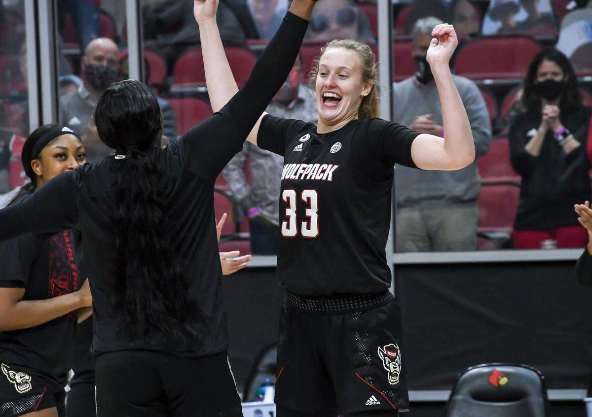 N.C. State’s Elissa Cunane (33) greets teammates before the Wolfpack’s game against Louisville at KFC Yum! Center in Louisville, Ky. Monday, February 1, 2021.
