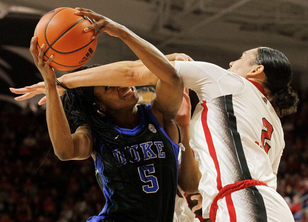 Duke’s Oluchi Okananwa is fouled by N.C. State’s Mimi Collins during the first half of the Wolfpack’s game on Sunday, Jan. 21, 2024, at Reynolds Coliseum in Raleigh, N.C.
