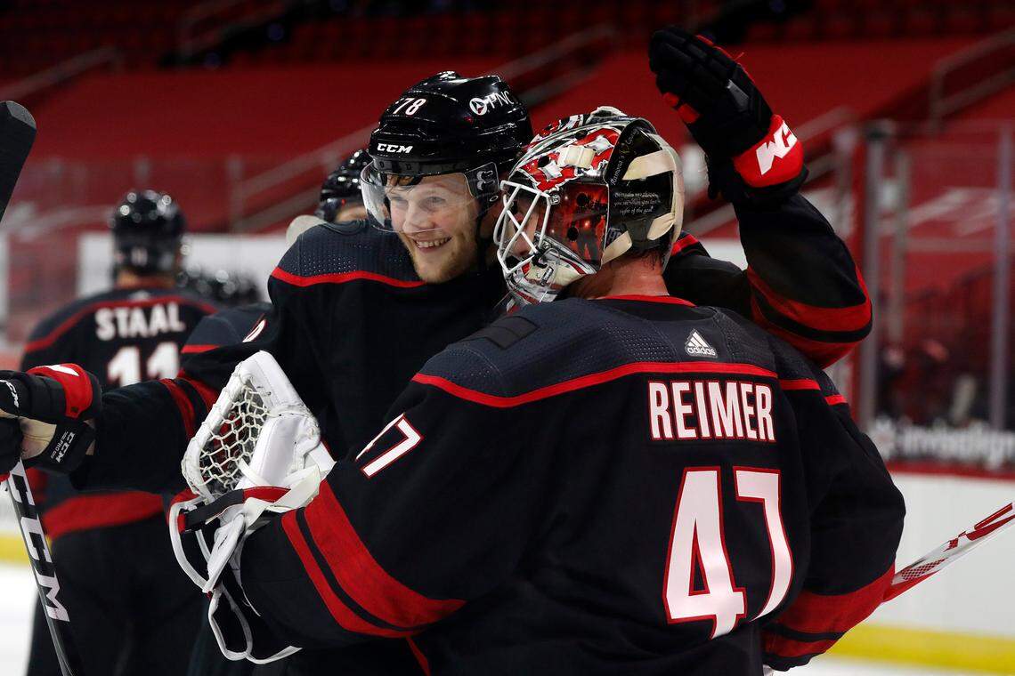 Carolina Hurricanes’ Steven Lorentz (78) congratulates goaltender James Reimer (47) following an NHL hockey game against the Dallas Stars in Raleigh, N.C., Saturday, Jan. 30, 2021. (AP Photo/Karl B DeBlaker)