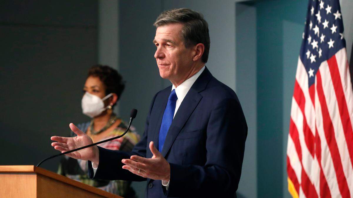 North Carolina Gov. Roy Cooper answers a question during a briefing at the Emergency Operations Center in Raleigh, N.C., Thursday, June 4, 2020.