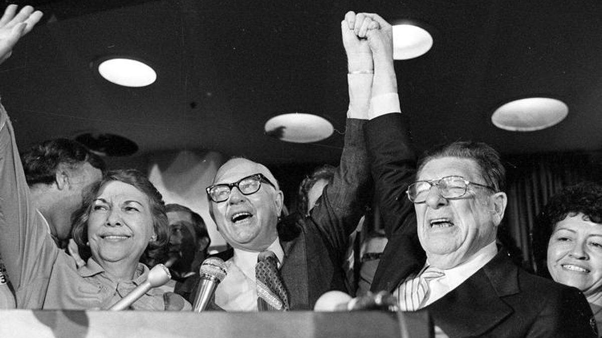 Paul Gann, left, and Howard Jarvis hold up their hands as their co-authored initiative Proposition 13 takes a commanding lead in the California primary, in Los Angeles, June 7, 1978. The cap distorted the housing markets and forced California to rely more heavily of sales and income taxes. A proposed income tax cap in North Carolina could tie the hands of future legislators and force increases in property and sales taxes.